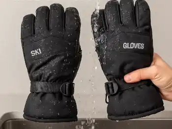 Image of washing ski gloves with water