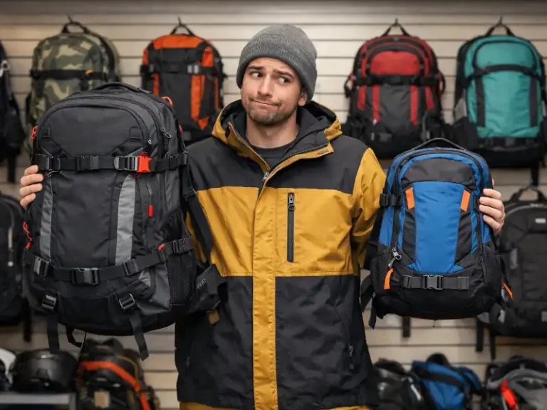 Image of a man choosing a snowboard backpack