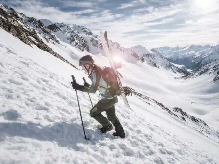 Splitboarder with backpack ascending mountain